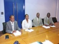 4 Bank of Mozambique staff seated around a conference table