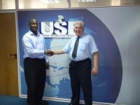 Manager of Securities Training Institute shakes hands with DevPar trainer in the USE