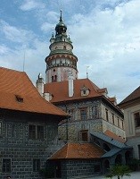 stone buildings with red tile roofs and a tower