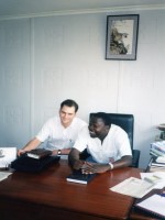DevPar consultant seated with Ugandan man at a desk